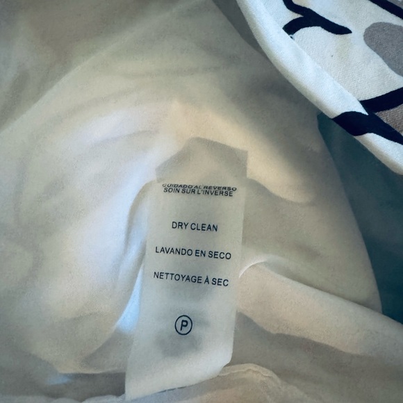 Teal blouse with teal and black highlights on a white skirt. - Picture 15 of 15